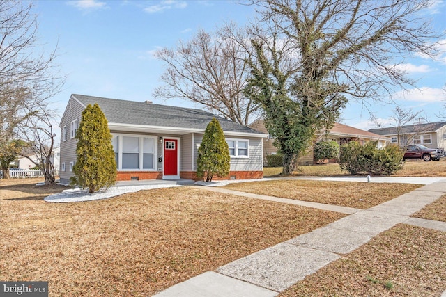 view of front facade with a front lawn, crawl space, a shingled roof, and fence