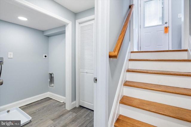 stairway featuring recessed lighting, wood finished floors, and baseboards