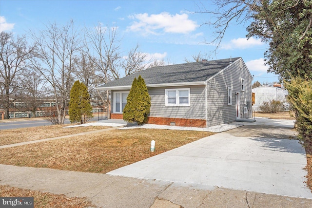 view of front of property featuring a front yard, crawl space, and concrete driveway