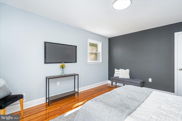 bedroom featuring wood finished floors and baseboards