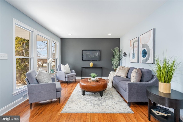 living room featuring recessed lighting, wood finished floors, and baseboards