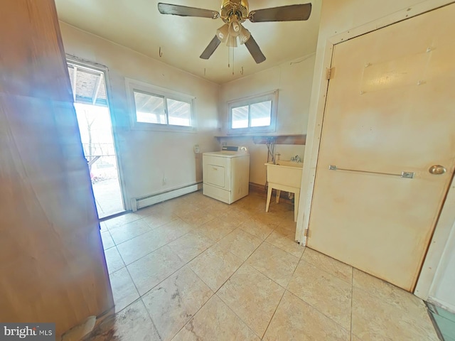 laundry area featuring a baseboard radiator, washer / clothes dryer, light tile patterned flooring, ceiling fan, and laundry area