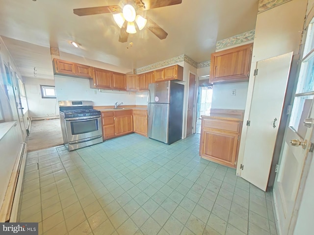 kitchen with a sink, stainless steel appliances, baseboard heating, and light countertops