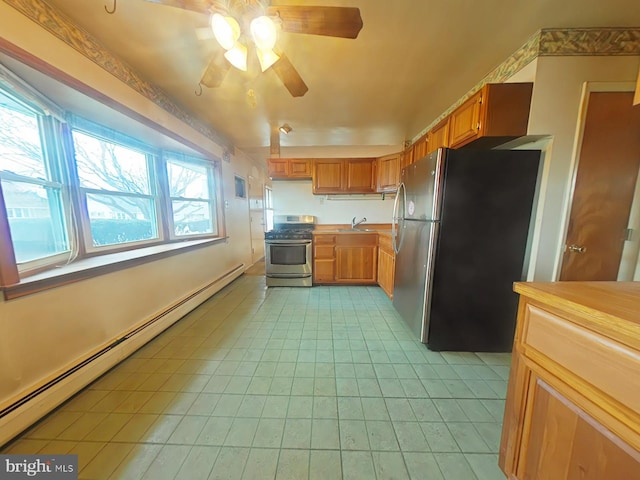 kitchen featuring light tile patterned floors, a baseboard radiator, stainless steel appliances, a sink, and brown cabinetry