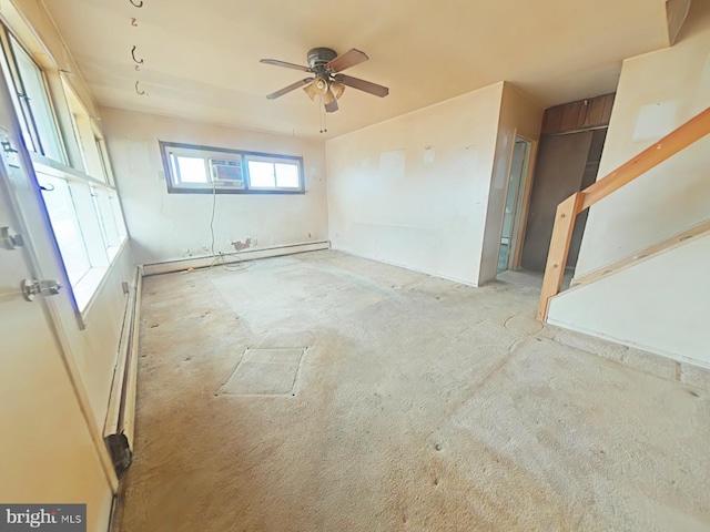 unfurnished room featuring ceiling fan and baseboard heating