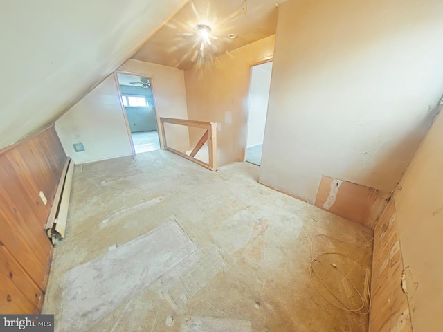 additional living space featuring lofted ceiling and a baseboard heating unit