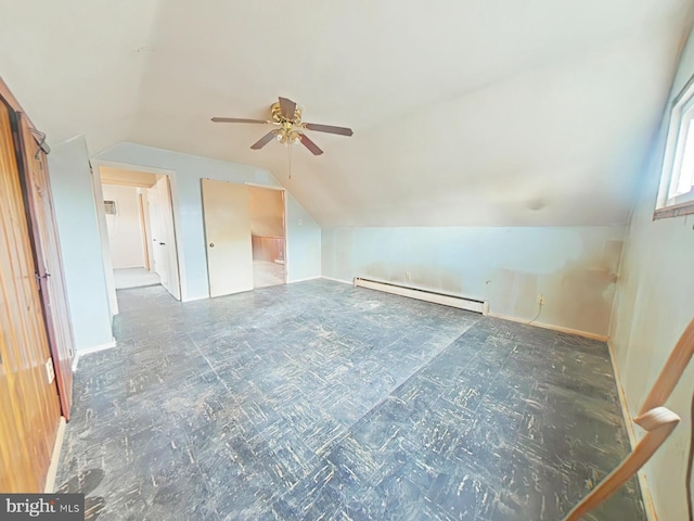 additional living space with vaulted ceiling and a baseboard radiator