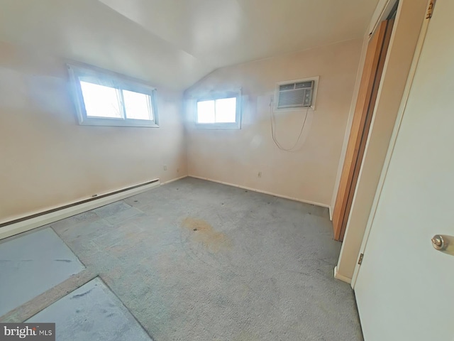 interior space with lofted ceiling, baseboard heating, and a wall mounted air conditioner