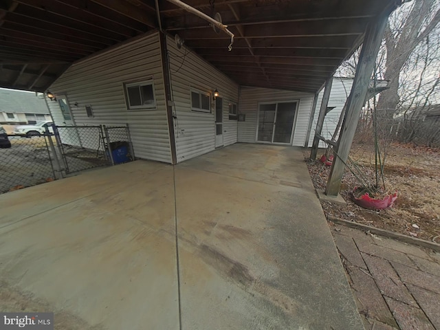 view of patio with a carport and concrete driveway