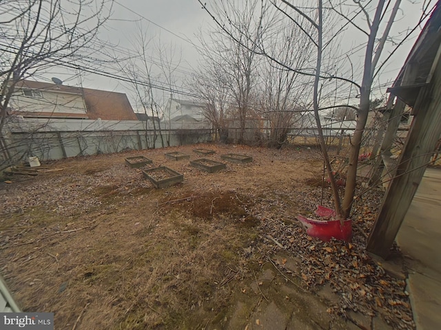 view of yard featuring a fenced backyard and a vegetable garden