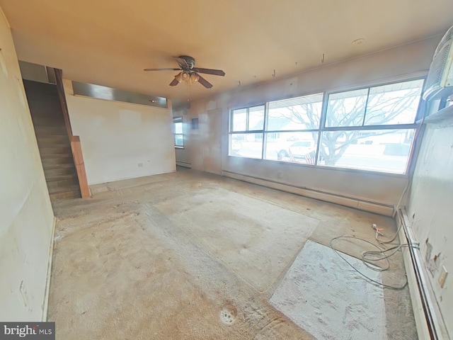 unfurnished room featuring ceiling fan and baseboard heating