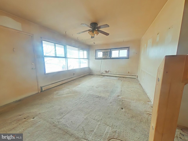 unfurnished room featuring ceiling fan and a baseboard heating unit