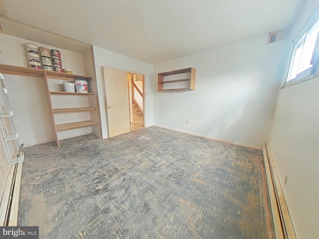 unfurnished bedroom featuring baseboard heating