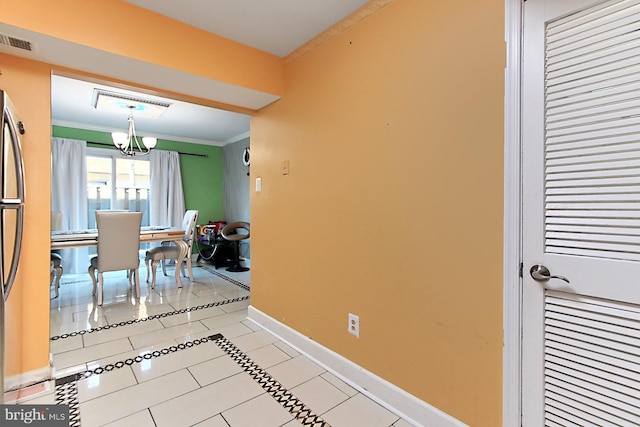 dining area featuring light tile patterned floors, crown molding, visible vents, baseboards, and an inviting chandelier