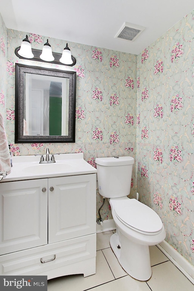 bathroom featuring visible vents, toilet, vanity, tile patterned flooring, and wallpapered walls