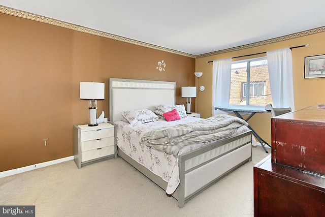 bedroom with carpet floors, ornamental molding, and baseboards