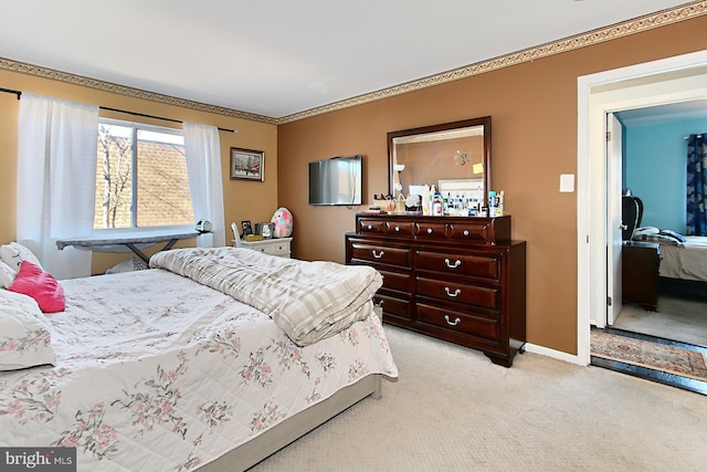 bedroom with baseboards, crown molding, and light colored carpet