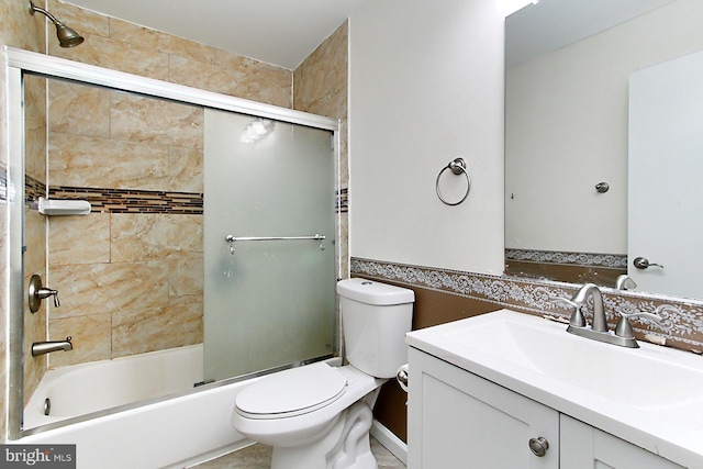 full bath with toilet, combined bath / shower with glass door, and vanity