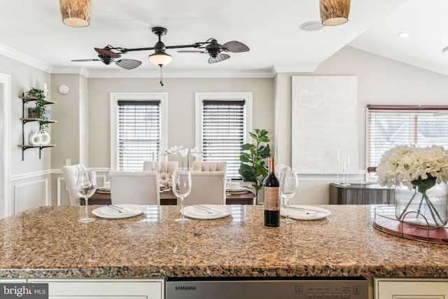 kitchen with stone counters, a ceiling fan, and crown molding