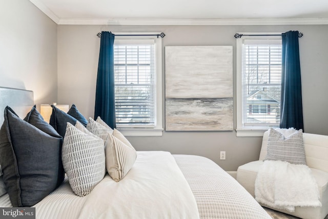 bedroom featuring multiple windows and crown molding