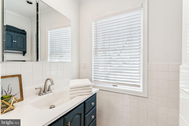 bathroom featuring ornamental molding, tile walls, and vanity