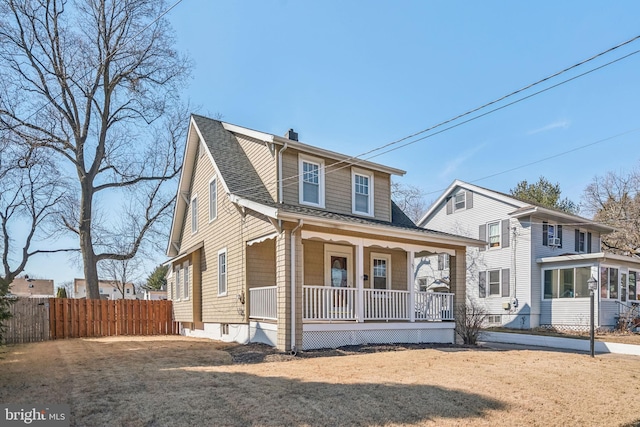 bungalow-style house featuring a chimney, a porch, a shingled roof, a front yard, and fence