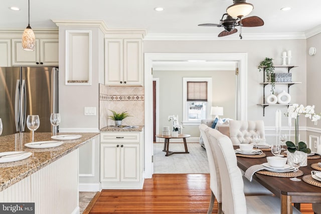 dining area featuring ceiling fan, light wood-style floors, recessed lighting, and crown molding