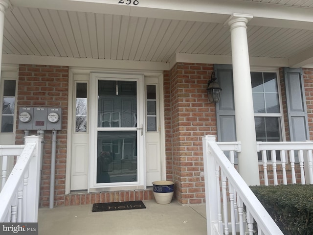 property entrance featuring brick siding