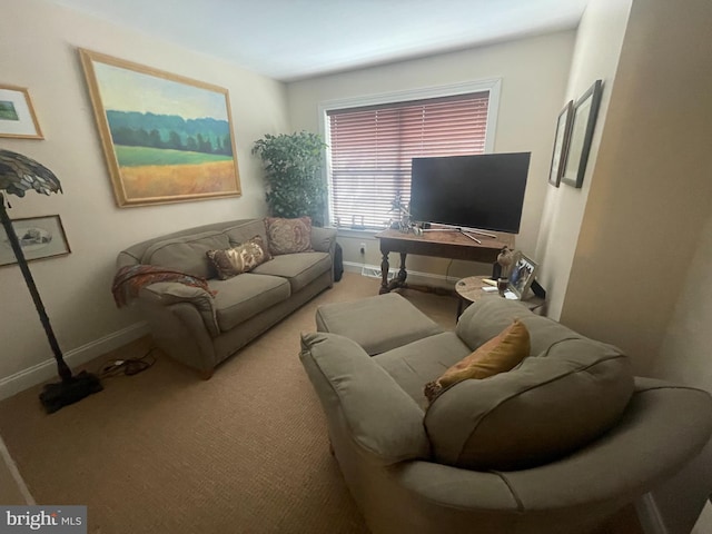 living area featuring carpet flooring and baseboards