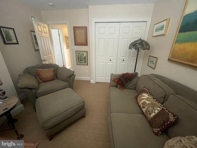 living area featuring carpet floors and baseboards