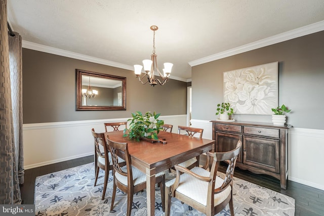 dining area featuring baseboards, crown molding, a chandelier, and dark wood-style flooring