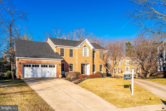 view of front facade featuring an attached garage, brick siding, concrete driveway, roof with shingles, and a front yard