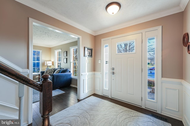 entryway featuring dark wood-style floors, visible vents, stairway, wainscoting, and a textured ceiling