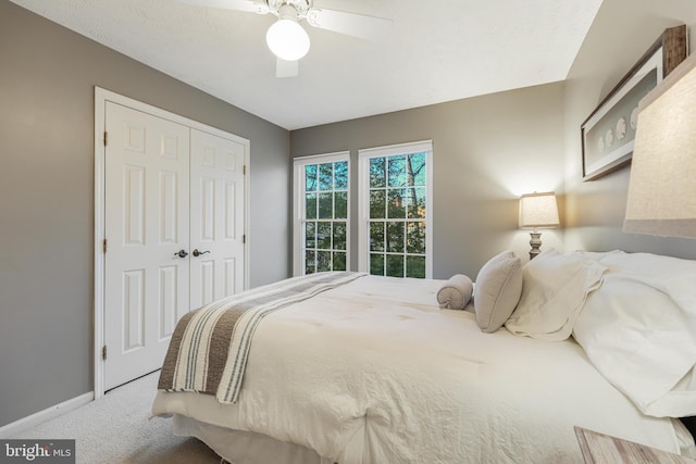 bedroom featuring ceiling fan, a closet, carpet flooring, and baseboards