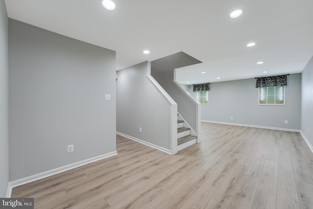 basement featuring recessed lighting, stairway, baseboards, and wood finished floors