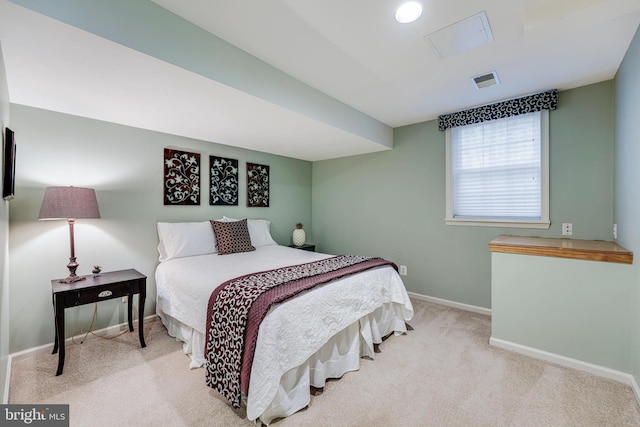 carpeted bedroom featuring visible vents and baseboards