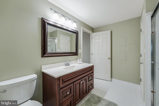 full bath featuring tile patterned flooring, a shower with shower door, vanity, and toilet