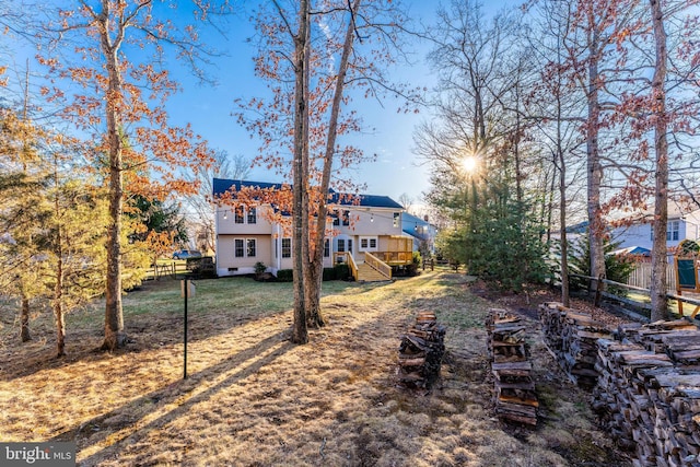 view of yard featuring fence and a wooden deck