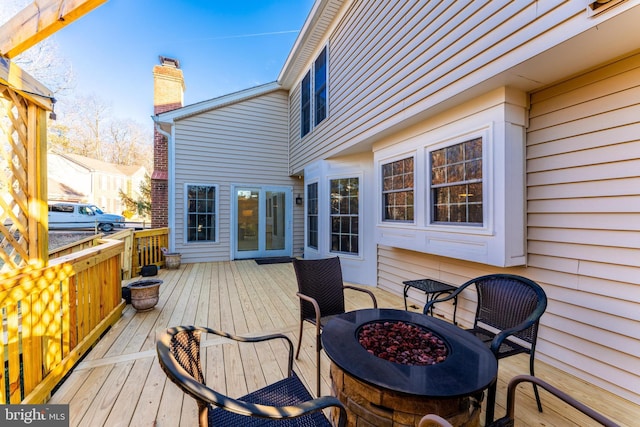 wooden terrace with an outdoor fire pit