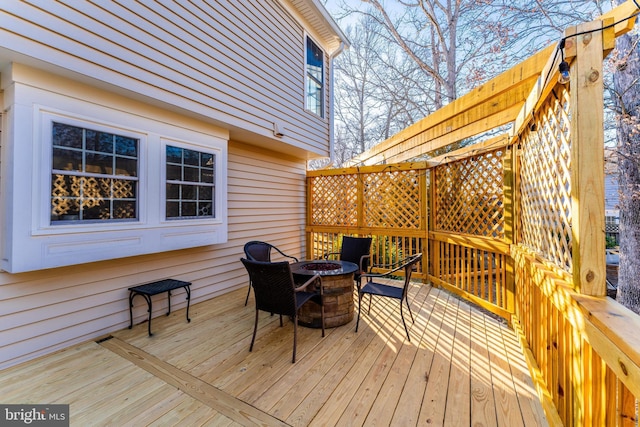 wooden terrace featuring a fire pit