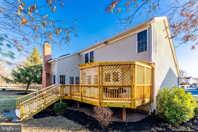 back of property with a wooden deck