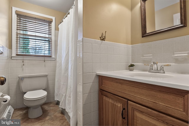 full bathroom featuring toilet, vanity, visible vents, tile walls, and tile patterned floors