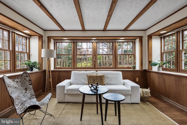 sunroom / solarium featuring beamed ceiling