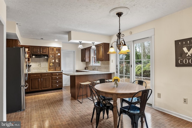 dining area with brick floor and baseboards