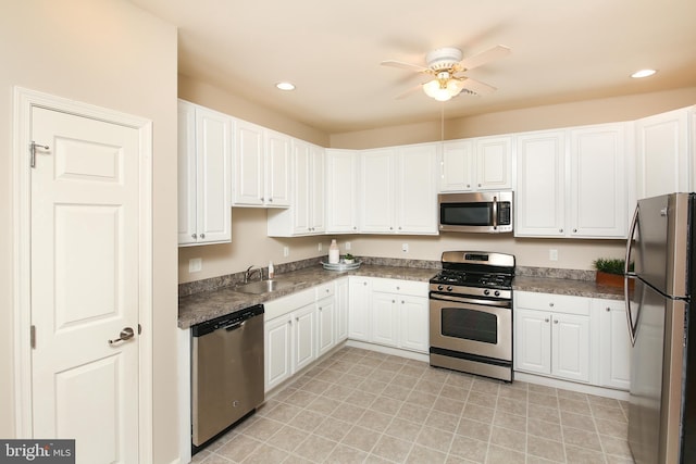 kitchen featuring white cabinetry, appliances with stainless steel finishes, a sink, and recessed lighting