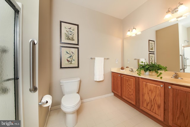 full bath featuring toilet, a stall shower, baseboards, and a sink