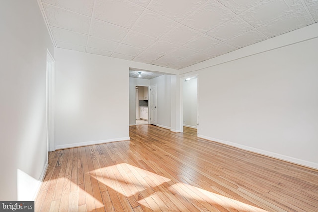 empty room with light wood-type flooring and baseboards