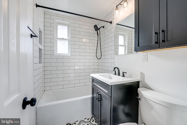 bathroom featuring vanity, toilet, and shower / bathtub combination