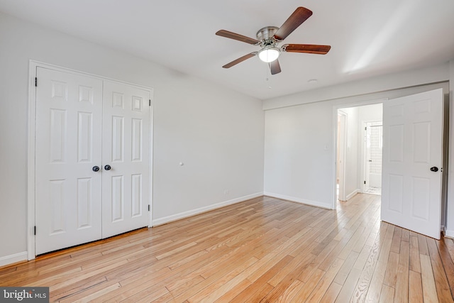 unfurnished bedroom featuring a closet, light wood-style flooring, and baseboards