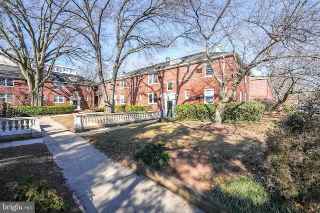 view of front of home with a residential view and brick siding